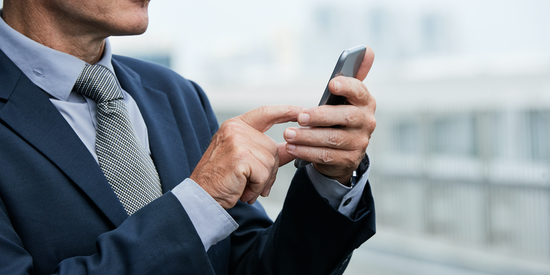 businessman-using-mobile-app-2BKX98W